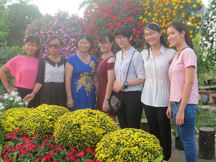 Tourists take a group photo in Sa Dec Flower Village